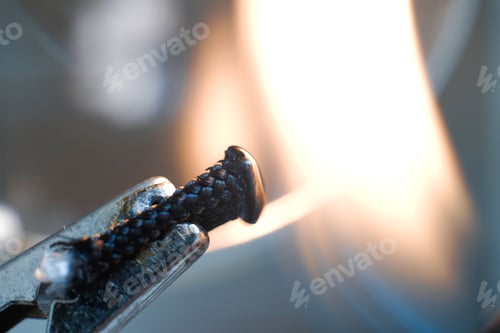 Preview: A Closeup Shot Of A Plier Holding A Piece Of Shoelac