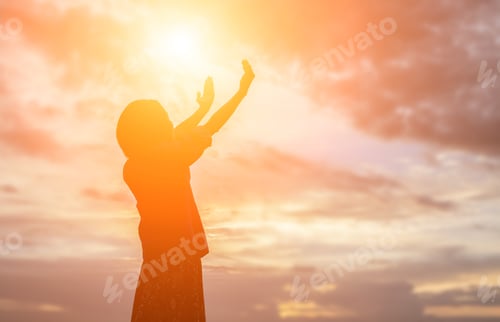 Preview: Silhouette Of Woman Praying Over Beautiful Sky Background