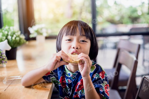 Preview: Portrait Of Little Girl Eating Cookies In The Kitchen
