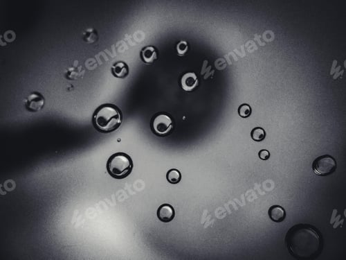 Preview: A Closeup Of Clear Bubbles Floating In The Air On A Dark Grey Background