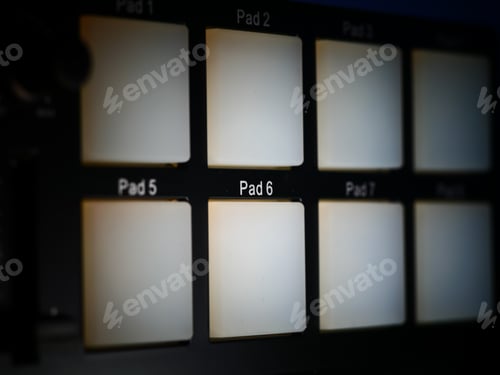 Preview: A Dramatic Shot Of Drum Pad Controller Buttons Lit With White Light