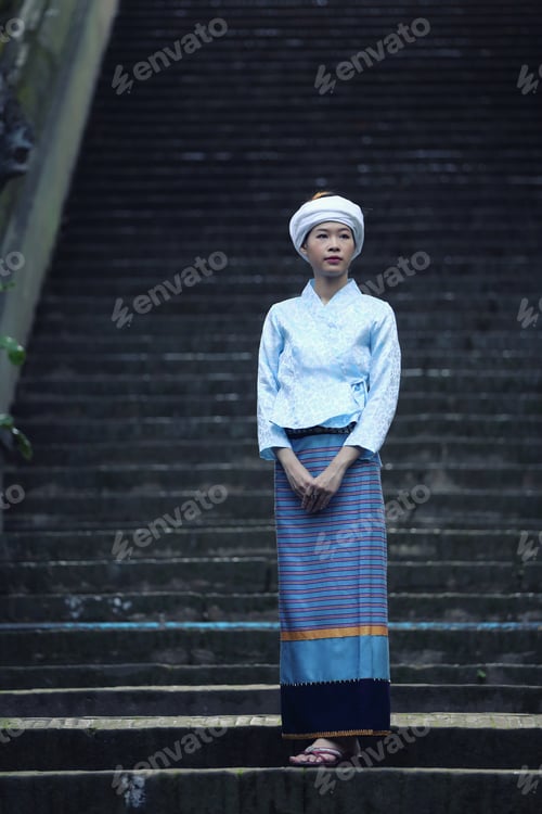 Preview: Portrait Of Thai Young Woman With Traditional Thai Dress In Thai Temple With Tree And Sunrise