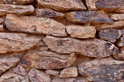 Preview: Various Reds, Browns, And Blacks Make Up A Colorful Old Rock Wall