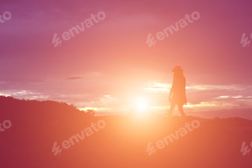 Preview: Silhouette Of Woman Praying Over Beautiful Sky Background