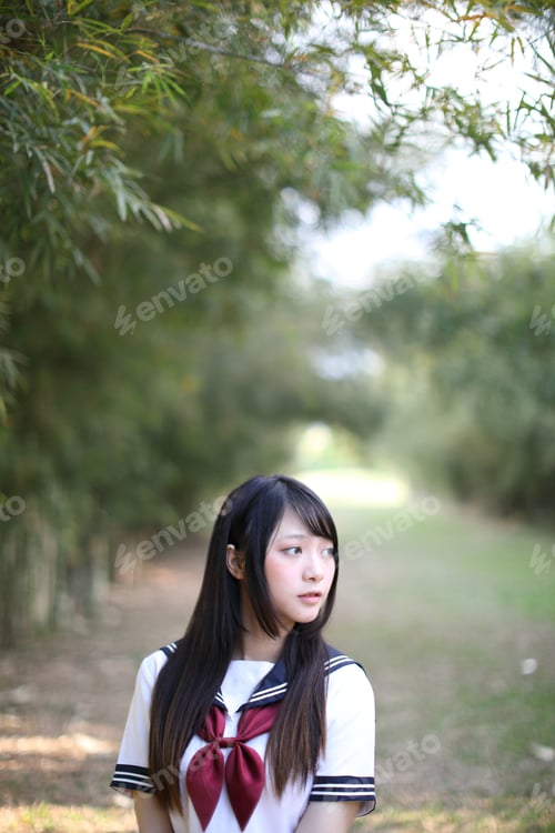 Preview: Portrait Of Beautiful Asian Japanese High School Girl Uniform Looking With Bamboo Forest Background