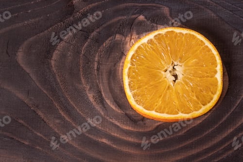 Preview: A Closeup Shot Of A Cut Half Orange On A Wooden Surface
