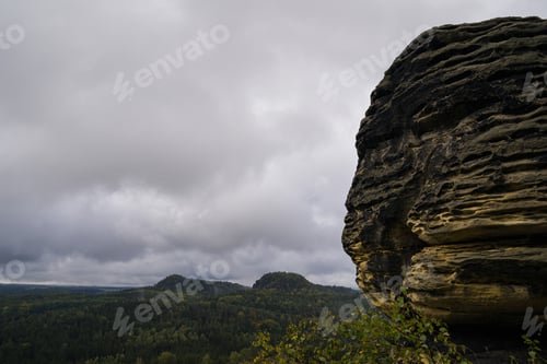 Preview: A Mesmerizing View Of Huge Rock Formation And Dense Green Trees In Saxon Switzerland National Park