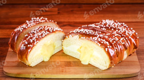 Preview: A Closeup Shot Of Freshly Baked Bread With Cream And Sesame Seeds On A Wooden Surface