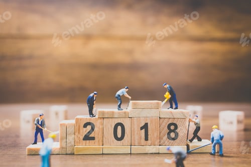 Preview: Miniature Worker Team Building Wooden Block Number 2018 On Wooden Background
