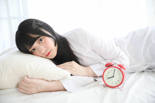Preview: Portrait Beautiful Asian Female Sitting With Clock At White Bedroom