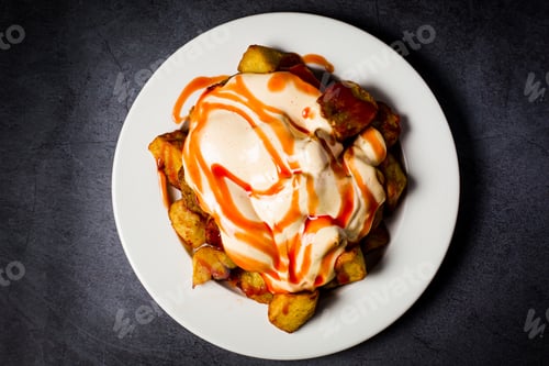 Preview: A High Angle Shot Of Potatoes With Brava Or Spicy Sauce
