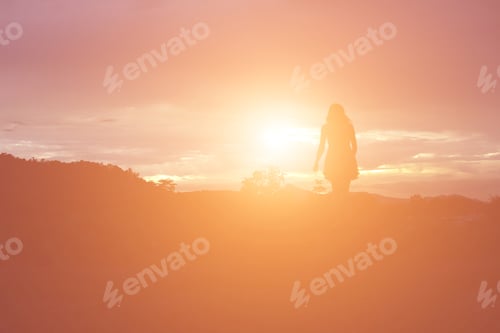 Preview: Silhouette Of Woman Praying Over Beautiful Sky Background