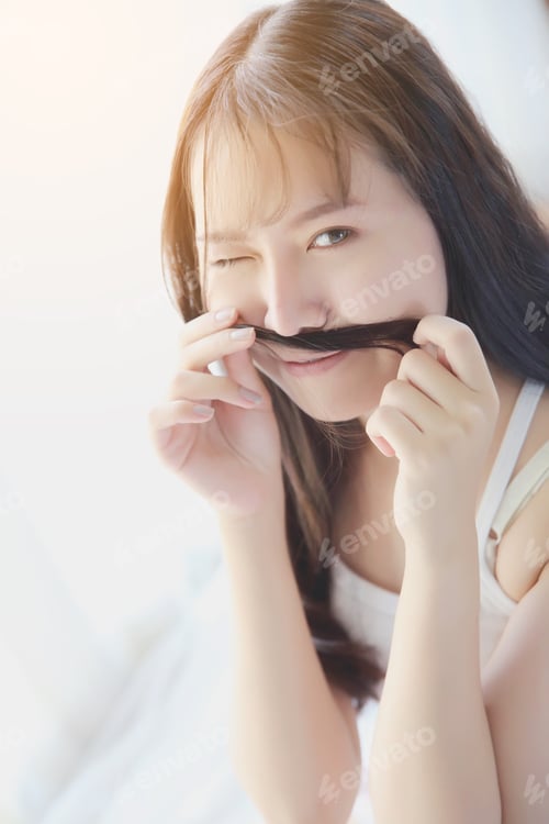 Preview: Asian Young Woman Smiling On White Bedroom
