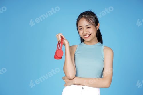Preview: Asian Young Attractive Beautiful Young Female Student On Blue Background