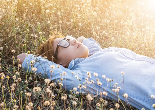 Preview: Young Hipster Woman Lying In Flower Field After She Tired For Reading