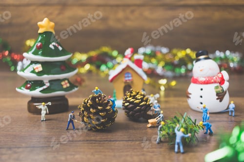 Preview: Creative Concept With Miniature People Creating Christmas Decorations On A Wooden Background