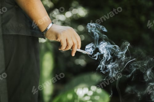 Preview: Hand Holding Cigarette With Smoke In Unhealthy Lifestyle