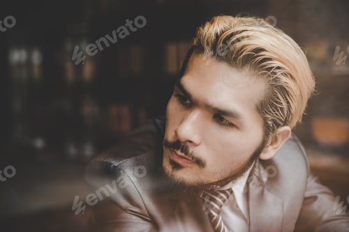 Preview: Young Businessman Sitting At Cafe Bar,Looking Away And Thinking.