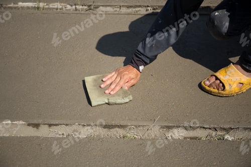 Preview: Worker Smooth Concrete Floor With Sponge In Construction Sites