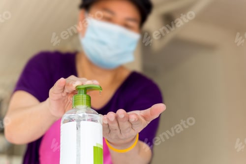 Preview: Woman With Face Mask Applying Alcohol Gel In Hand To Preventing Germs, Coronavirus