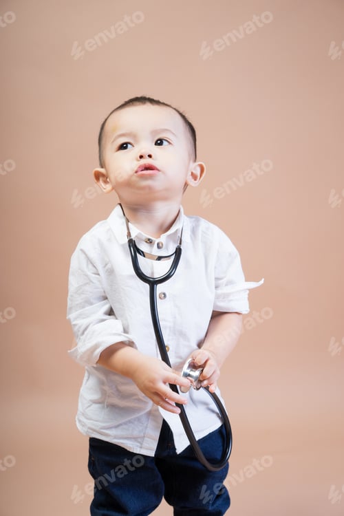 Preview: Portrait Of An Asian Male Child Wearing A White Shirt With A Stethoscope On A Brown Background