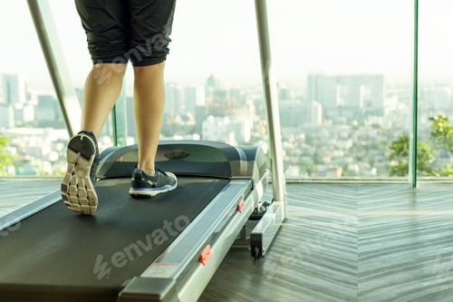 Preview: Woman Walking On A Treadmill Exercise In The Gym In The Morning