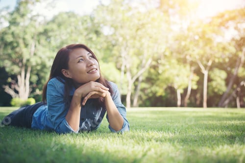 Preview: Charming Smiling Young Hipster Woman Lying On Green Grass.