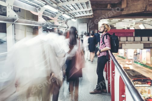 Preview: Hipster Bearded Man Standing In The Train Station With People Motion Background While Traveling At