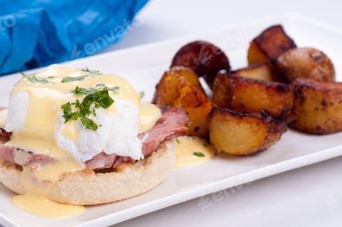 Preview: A Closeup Shot Ofeggs Benedict With Farm Fresh Eggs And Ham And Fried Potatoes
