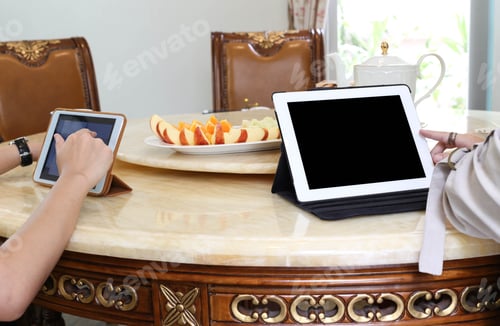 Preview: Business People Having Lunch And Work With Tablet Tea And Fresh Fruit On The Table