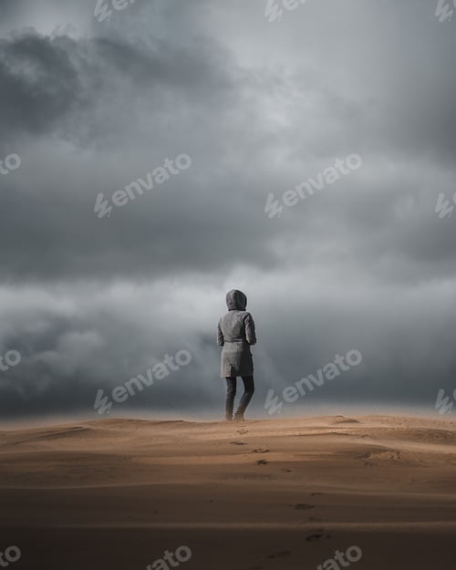 Preview: A Back View Of A Male On The Sandy Beach On A Dark Day