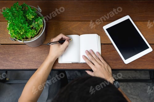 Preview: Business Man Hand Using Laptop And Write Note Inspire Idea On Wood Desk, Startup Concept. Top View.