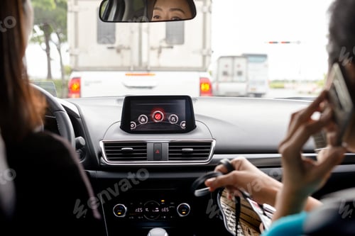 Preview: Two Woman Friends Driving Modern Car On Country Road.