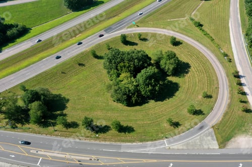 Preview: A High Angle Shot Of An Exit With Shrubs And Green Grass