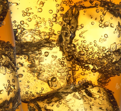 Preview: A Closeup Shot Of Ice And Bubbles In A Yellow Liquid