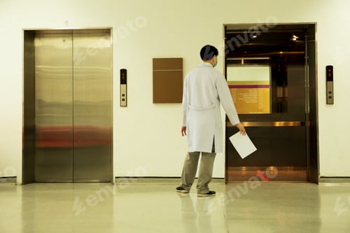 Preview: Doctor With Paper Report And Elevator With Line Position Prevention Covid-19.