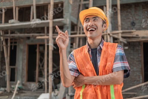 Preview: An Asian Contractor Stands Wearing A Safety Helmet And Vest With A Gesture Of Getting An Idea In