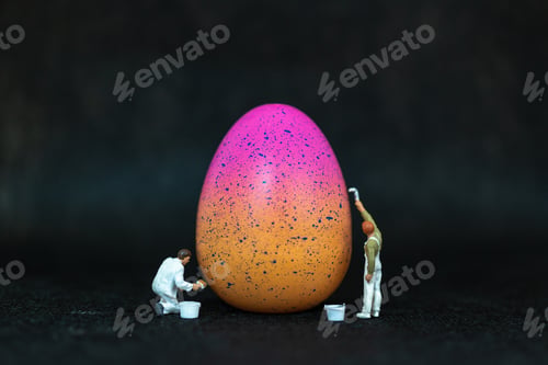 Preview: Miniature People Painting Easter-Eggs For Easter Day On Black Background