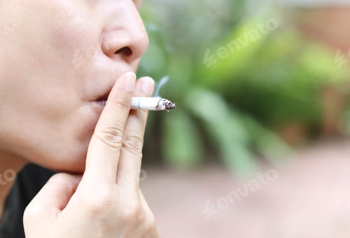 Preview: Woman Smokes A Cigarette Outdoor At The Park