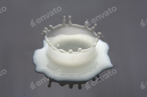 Preview: A Closeup Shot Of A Fresh Milk Splashing On A Reflective Surface Forming A Crown