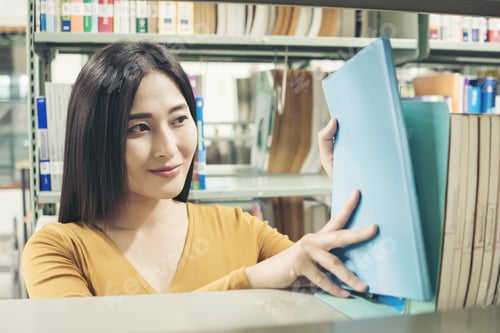 Preview: Young Students Finding Books In University Library. Education Concept.
