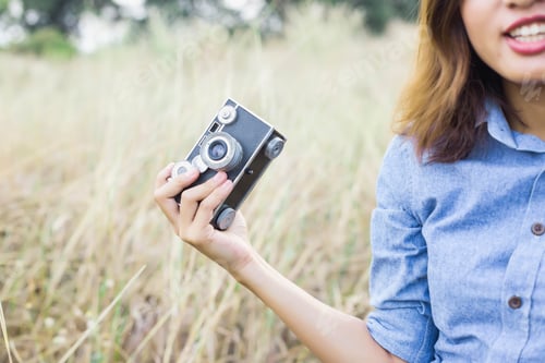 Preview: Woman Photographed In A Meadow With A Camera.