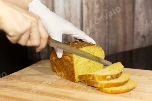 Preview: Chef Hands Cutting Pumpkin Bread On The Wooden Board, Selective Focus.