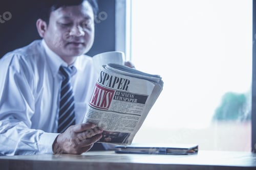 Preview: Man Reading Newspaper About Business News Morning Update At Coffee Cafe