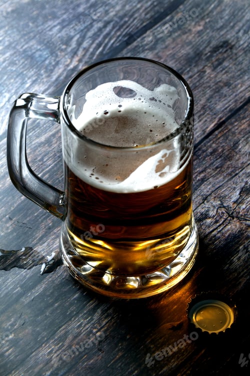Preview: A Vertical Shot Of A Mug Of Beer On Wooden Table