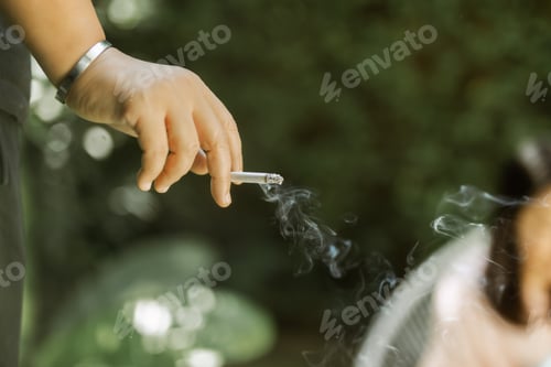 Preview: Harmful Habit Hand Holding Cigarette With Smoke On Woman.