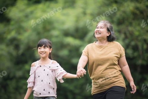 Preview: Grandmother Playing With Granddaughter Outdoors At The Park