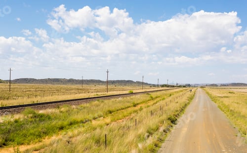 Preview: A Rural Road Next To A Railway In A Field