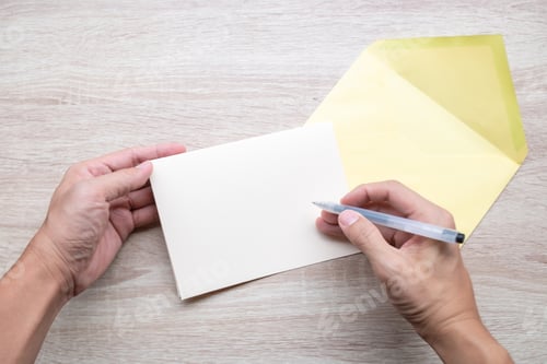 Preview: Male Hands Writing Empty Cards On Wooden Table.