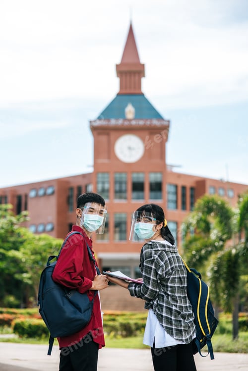 Preview: Male And Female Students Wear Masks And Stand In Front Of The University.